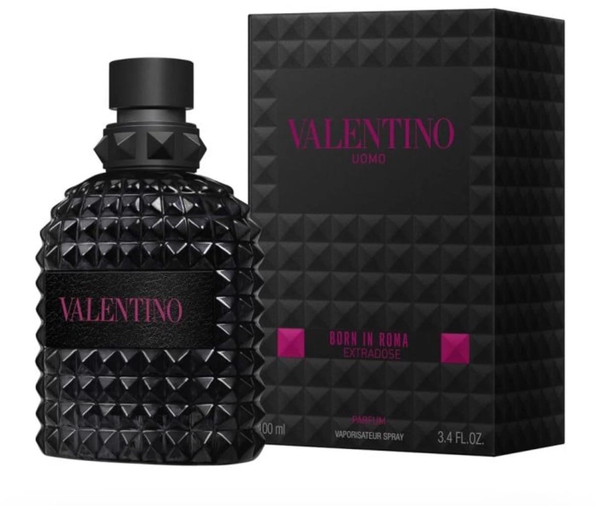 Valentino Uomo Born in Bona Extraordinaire perfume bottle and packaging box. The bottle is textured black with a faceted cap, and the box features a matching geometric pattern with pink and white text.
