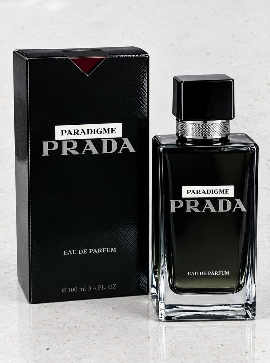 Prada Paradigme Eau de Parfum bottle and its black packaging box on a light marble surface.